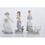 Three Lladro figures, including lady with basket of flowers, a lady with geese group,