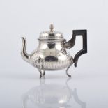A French silver teapot, Minerva mark, squat form on three legs, embossed and engraved decoration,