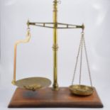 Set of Victorian brass balance scales, by W & T Avery, Birmingham, mahogany platform, width 56cm.