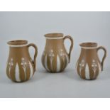 Set of three Norwood stoneware graduating jugs.