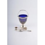 A silver sugar basket with blue glass liner,