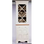 Painted bookcase, of narrow proportions, glazed door over a drawer and cupboard, W66cm, H206cm.