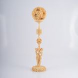 Cantonese carved ivory puzzle ball on stand, Early 20th Century, stand modelled with figures,