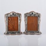 A matched pair of Art Nouveau silver photograph frames, the surround with sinuous Iris design,