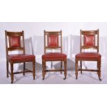 A set of six Victorian oak dining chairs, leatherette upholstered backs and seats,