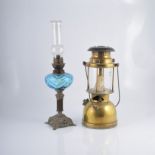 Two brass oil lamps, another lamp,