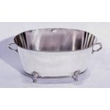 An oval silver-plated champagne bath, bead edge decoration to top and bottom.