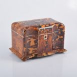 A Regency tortoiseshell tea caddy, serpentine front, white metal stringing,