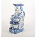 Delft Toby jug, modelled as Mr Toby, seated holding a quart and glass,