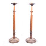 Pair of Victorian oak standard candlesticks, circular drip pans, turned columns, circular bases,