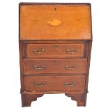 Edwardian walnut and inlaid bureau, fall front with inlaid shell motif above three drawers,