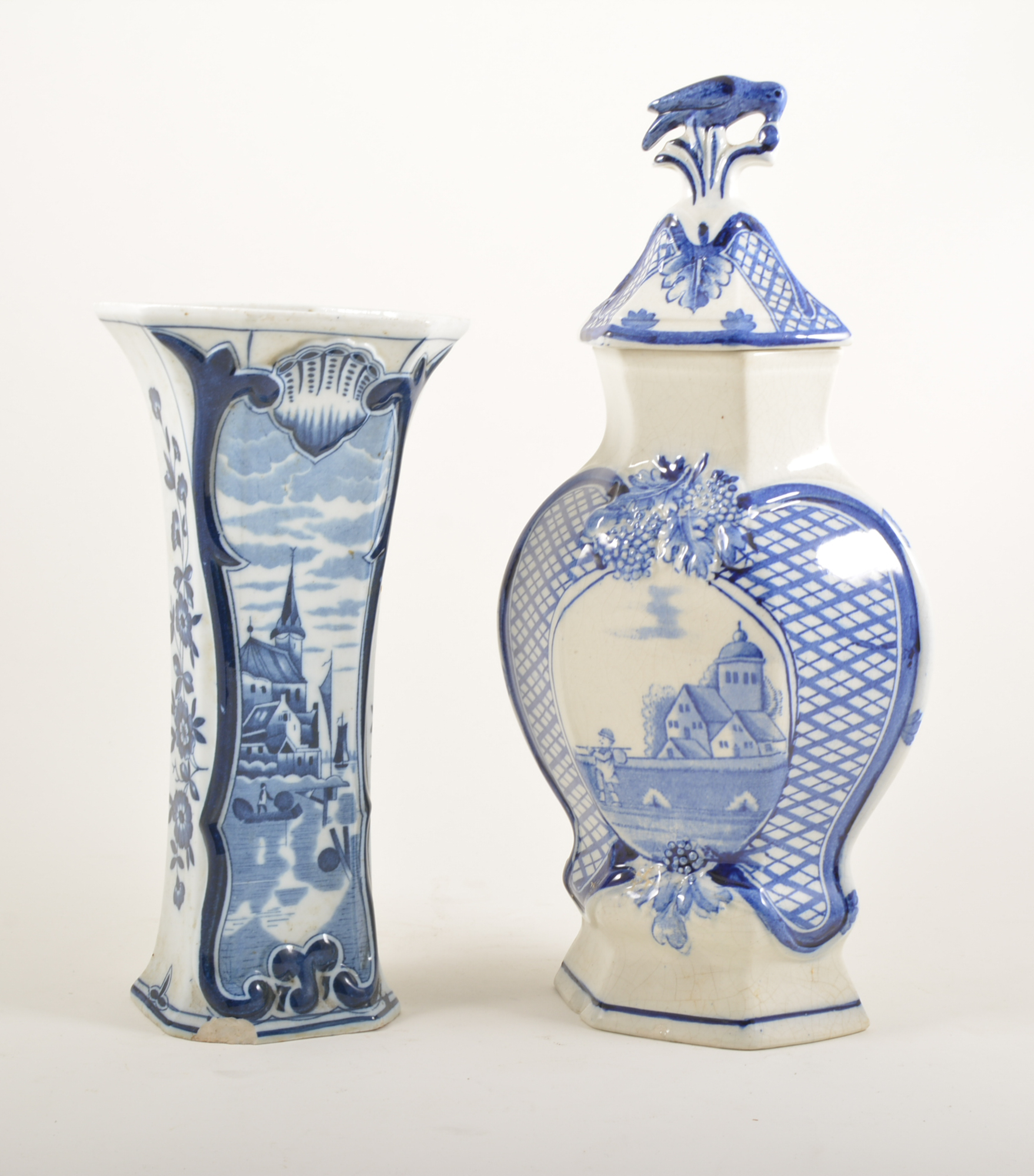 Delft jar, lozenge baluster form, the cover with a bird finial,height 35cm; four Delft vases,