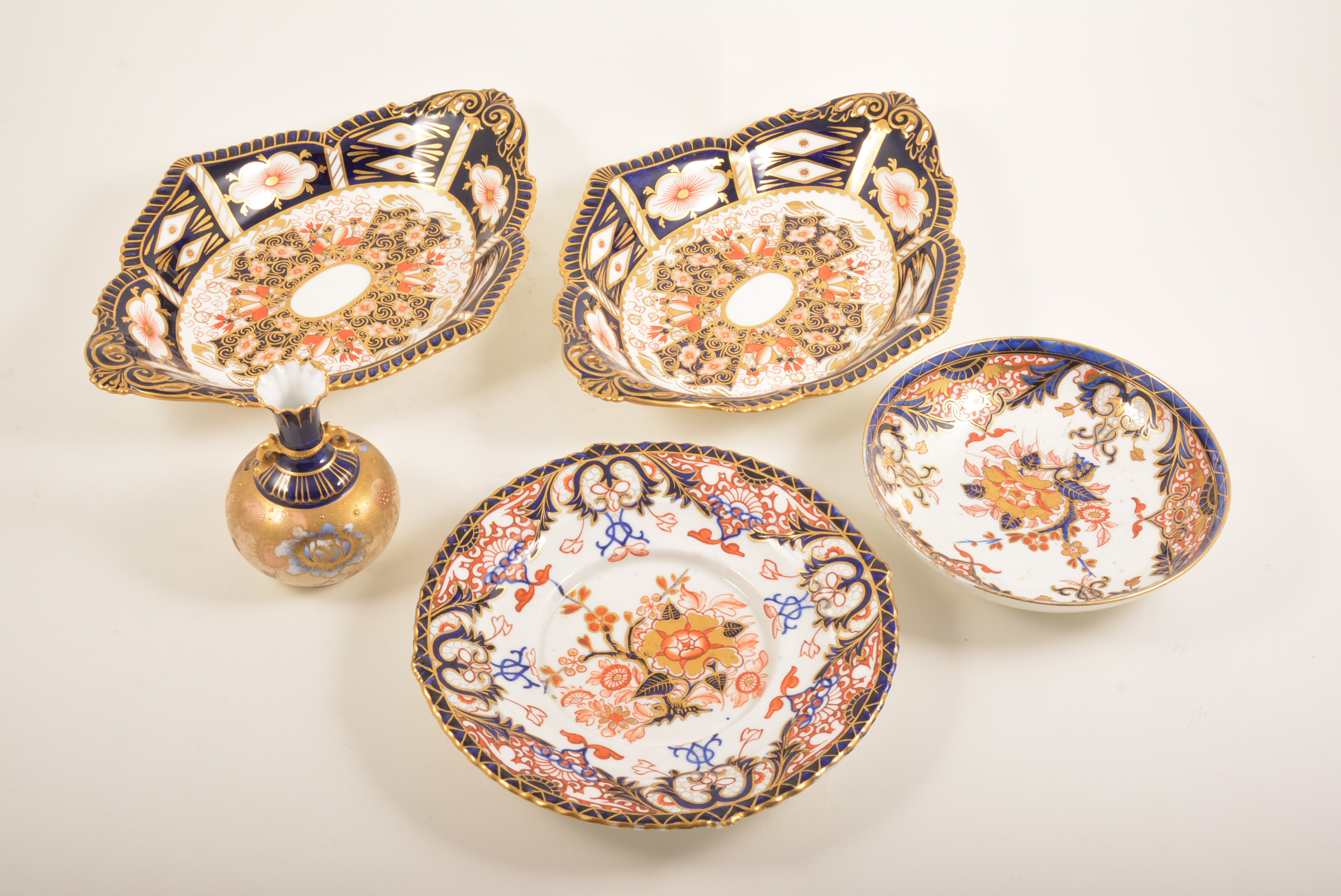 Two Royal Crown Derby dishes, Imari pattern, together with two others and a small vase,