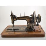Frister Rossmann case sewing machine, and four maplewood picture frames with Victorian photographs.