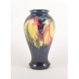 Walter Moorcroft, a 'Leaf and Berry' baluster shaped vase, c1950, 18cm.