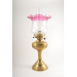 Brass oil lamp, tinted and frosted shade, 55cm.