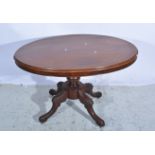 Victorian walnut loo table, oval tilt top, turned column, carved legs, 112 x 82cm.