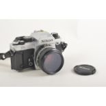 Nikon FA SLR camera with manual.