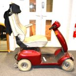 Karelma Mobility Scooter, grey leather seat with maroon bodywork.