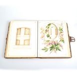 Leather embossed Edwardian photograph album, the internal mounts decorated with English flowers.