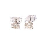 A pair of diamond single stone earrings, one brilliant cut diamond four claw set to each,