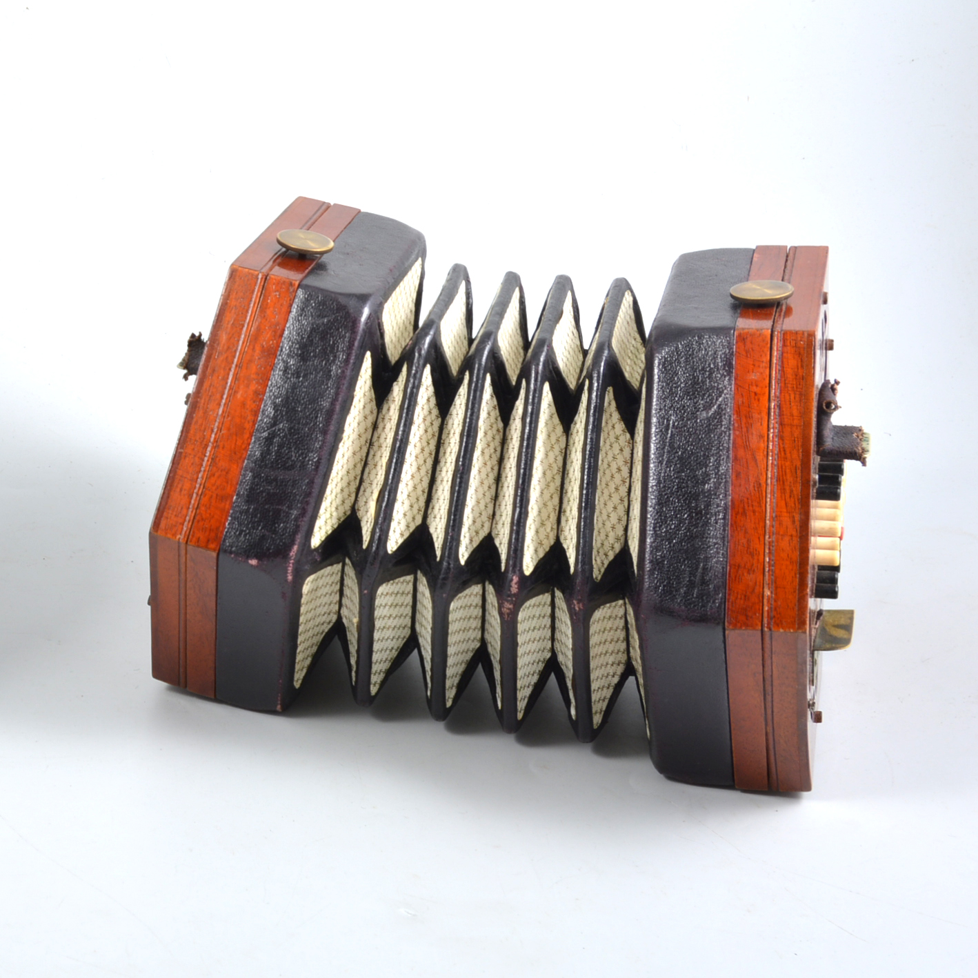 A Lachanel & Co Patent Concertina the hexagonal fret-cut stained wood ends with forty-eight buttons
