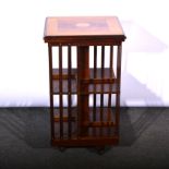 Revolving bookcase, satinwood top with inlaid fan motif, crossbanding, above two tiers of shelves,