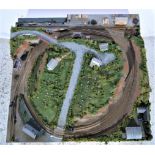 N gauge railway layout, mounted on wooden board, it comes with a circle of track, engine sheds,