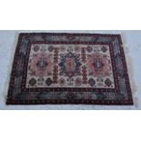 Small Persian pattern mat, three rectangular tiles on a pale ground within stylised floral border,