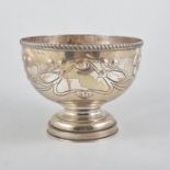 An Edward VII silver bowl in the art nouveau style, embossed with scrolling flower buds,