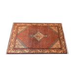 Araak rug, lozenge medallion conforming spandrels on a red field with boteh motifs, narrow border,