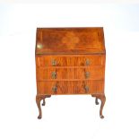 Walnut bureau, 1930s, fall-front enclosing a fitted interior, above three long drawers,