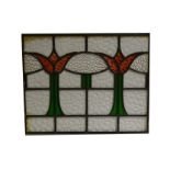 Two leaded and stained glass window panels, with stylised red tulips,