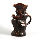 A Staffordshire treacle glazed toby jug, late 19th century,