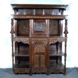 Joined oak court cupboard, in part 18th Century, the upper section with a carved cornice,