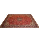 Sarough carpet, medallion on a patterned red ground floral field, border within guards, 385 x 283cm.