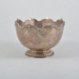 An Edward VII silver bowl, plain polished design with a monteith style border,