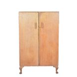 Light oak tallboy, plain rectangular form, the interior fitted with slides and drawers, two doors,