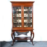 Edwardian walnut display cabinet on stand, fitted with three adjustable shelves,