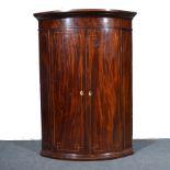 Georgian flame mahogany hanging bow front corner cabinet, box strung outlines,