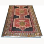 Caucasian pattern runner, four stepped medallions joined on a pole against a dark ground,
