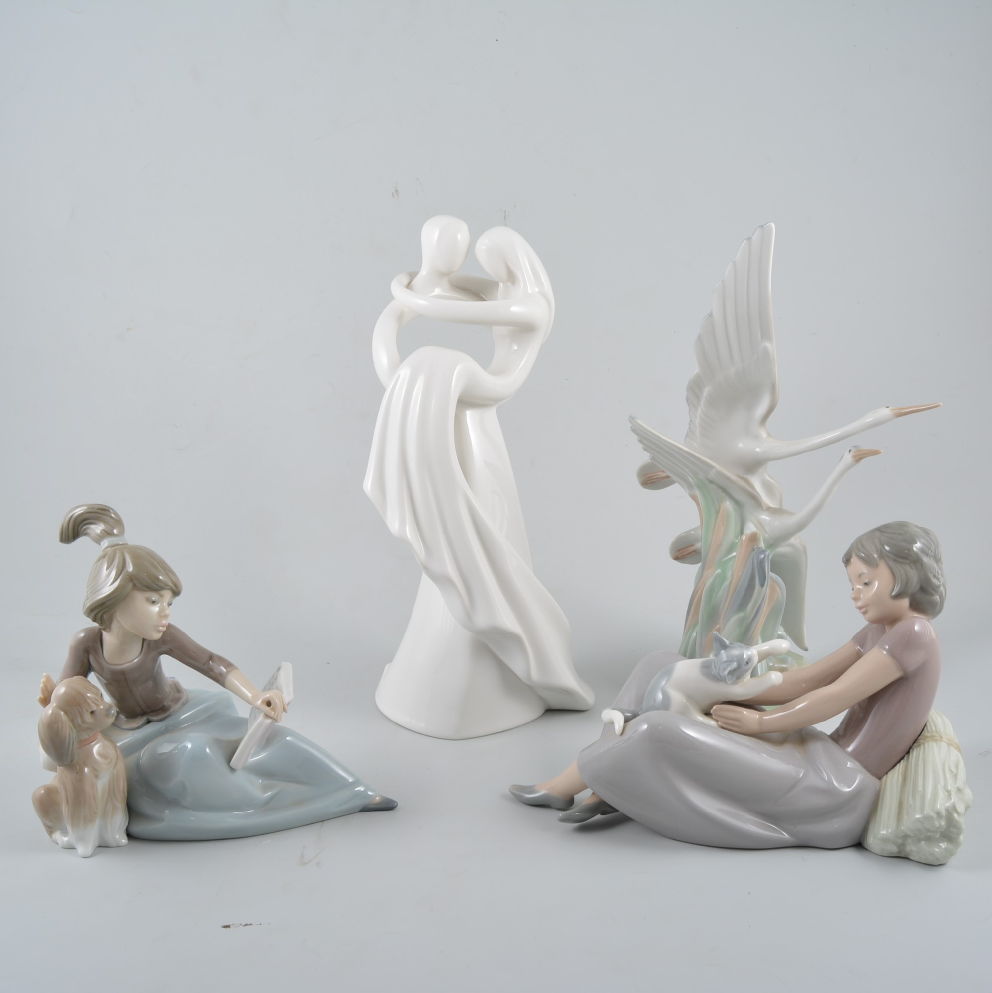 Nine Nao/ Lladro figures including a Circle of Love figure "Infinite Love",