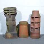 Collection of five terracotta chimney pots, 90cm and smaller; plus one other.