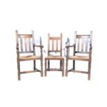 Three Victorian oak dining chairs, one single and two carvers, drop in rush seats.