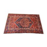 Hamadan rug, central medallion within an octagon device patterned red field, border within guards,