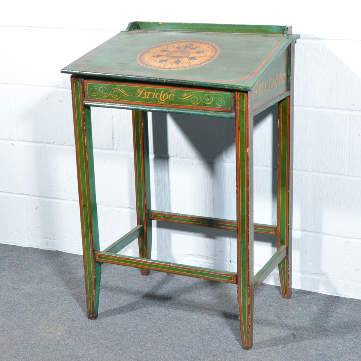 Victorian painted pine desk, slope front, painted with a view of a ship, HMS Dolphin,