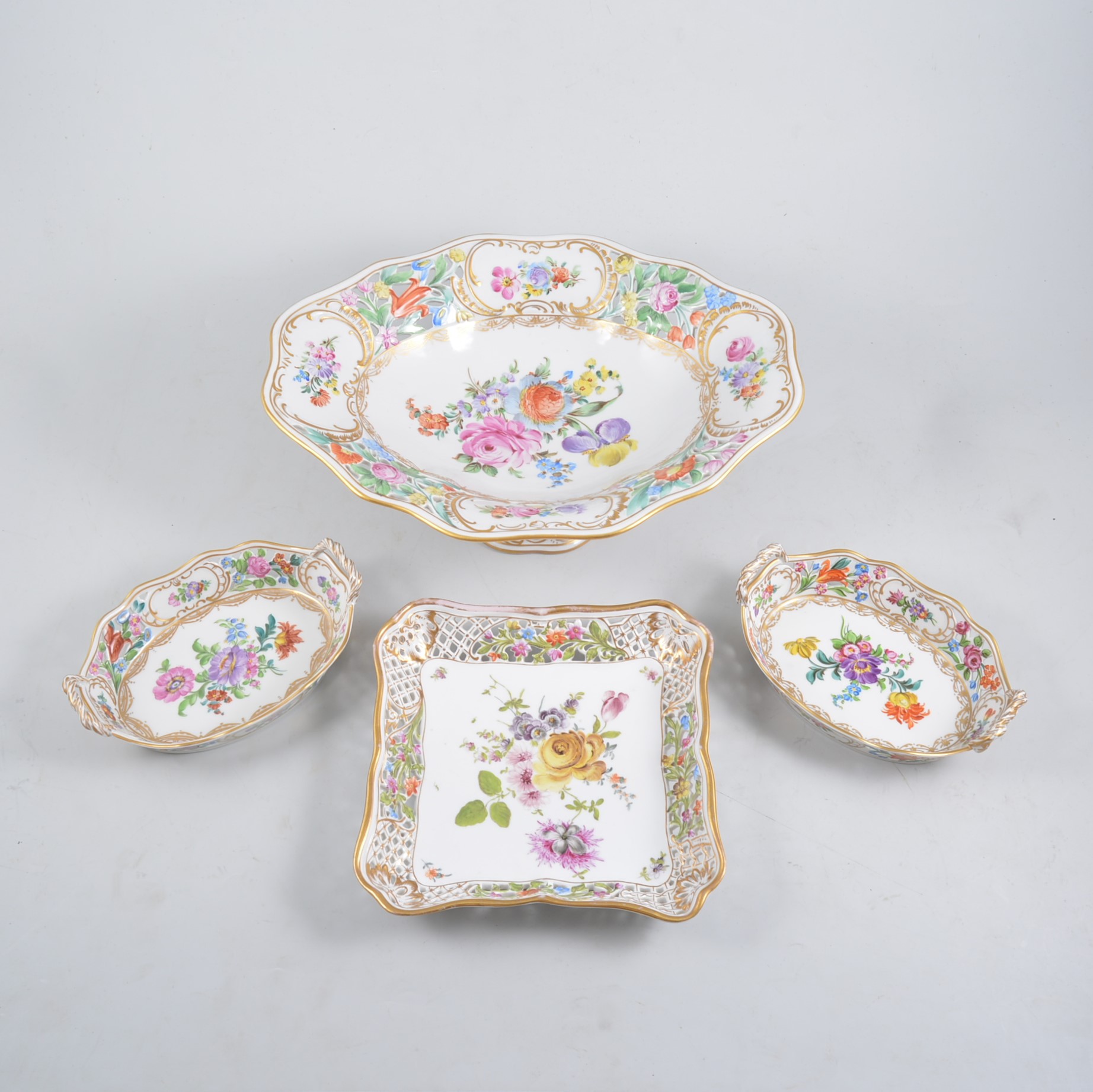 Large Dresden centre bowl, reticulated rim, floral painted design, two pairs of twin-handled dishes,