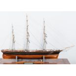 A fine hand-built wooden scale model ship, Cutty Sark, on a painted wooden stand,