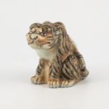 Japanese porcelain model of a sitting Tiger, probably Meiji, naturalistic colouring, 13cm.