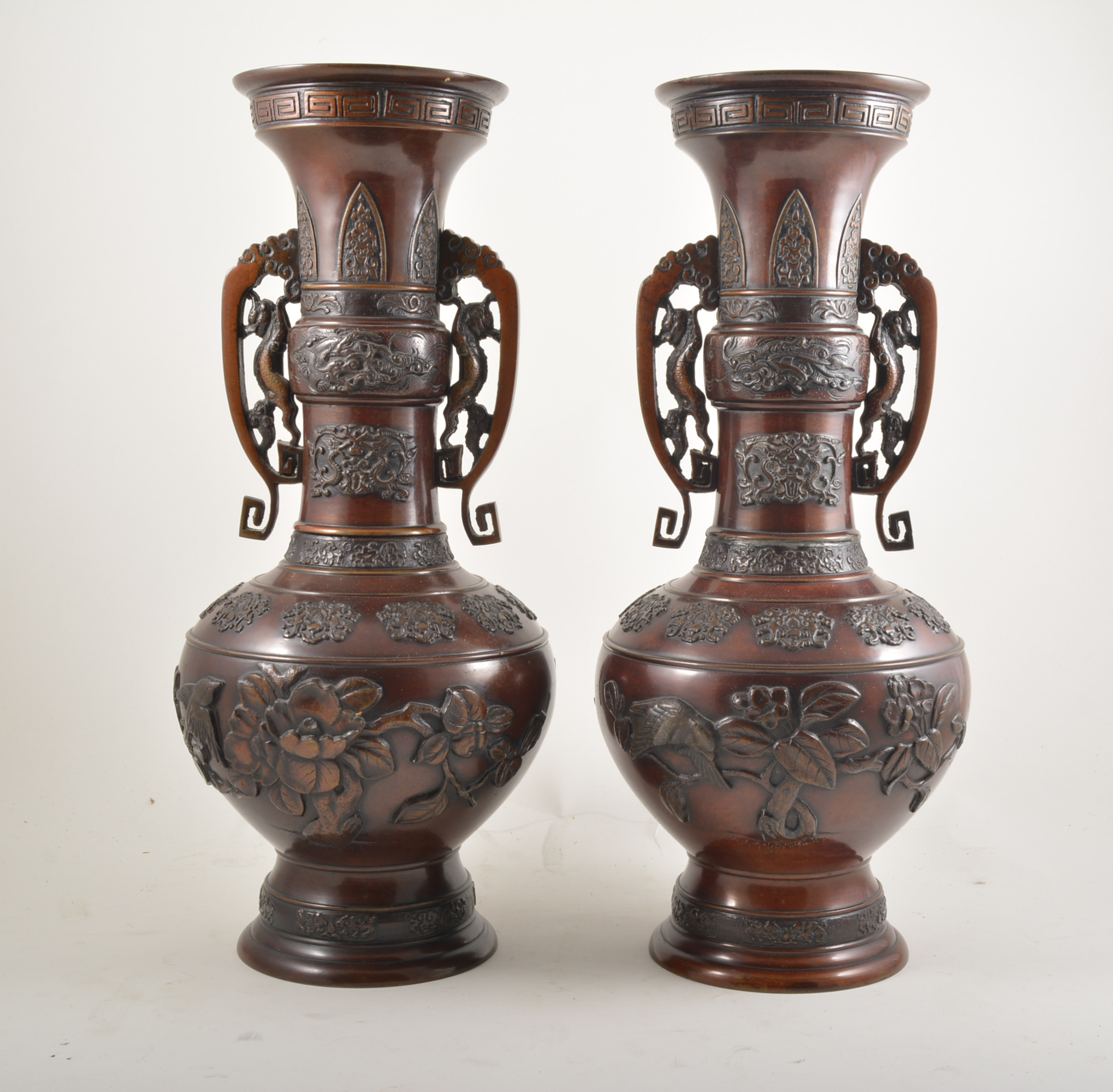 Pair of Chinese bronze vases, archaic form, twin scrolled handles, applied motifs,